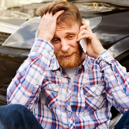 Man feeling talking on a phone after car accident