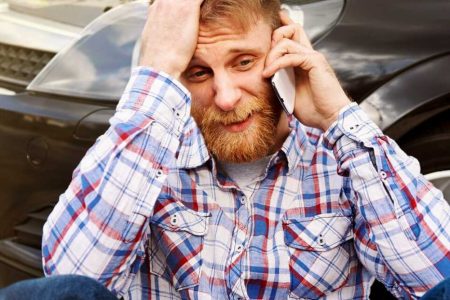 Man feeling talking on a phone after car accident