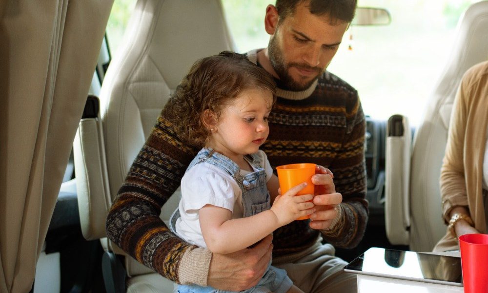 A baby and his dad enjoy the comfortable journey