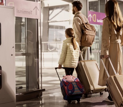 Guys walk into airport and get ready for family travel 