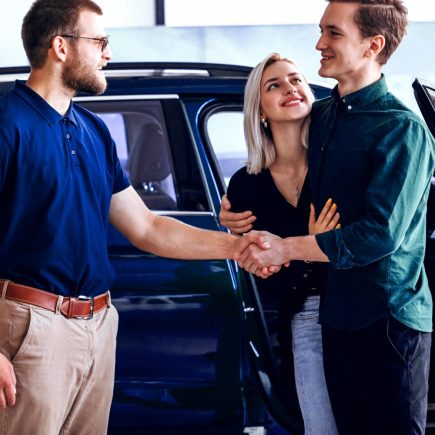 Guys shaking hands because one of them is buying a new car
