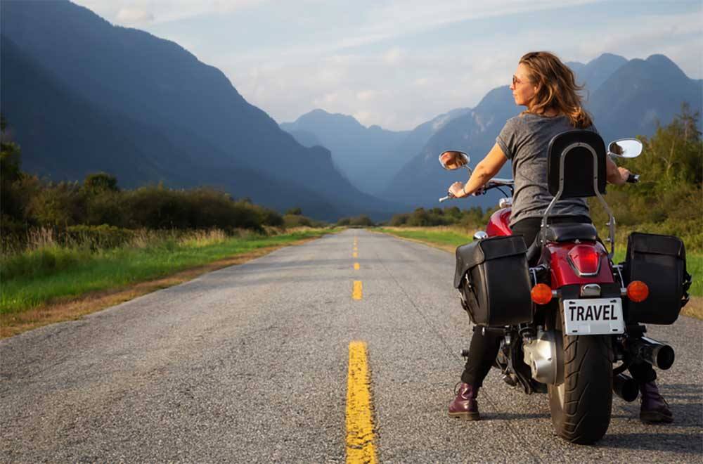 A woman on a motorcycle for a test drive before buying it 